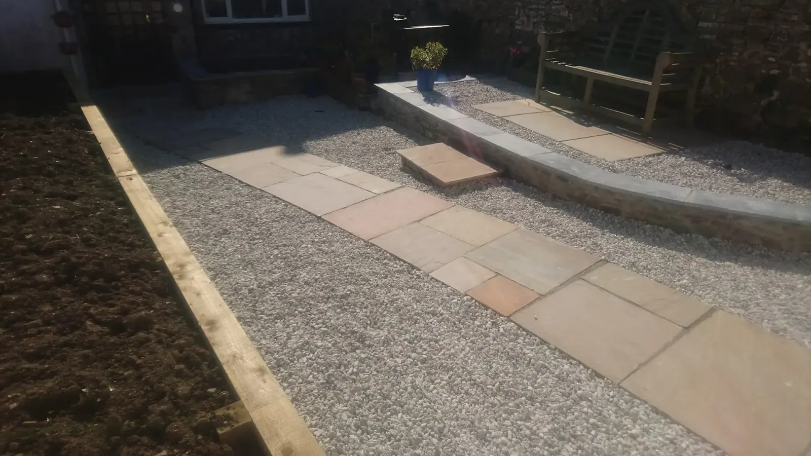 Finished courtyard with raised beds, gravel and paving