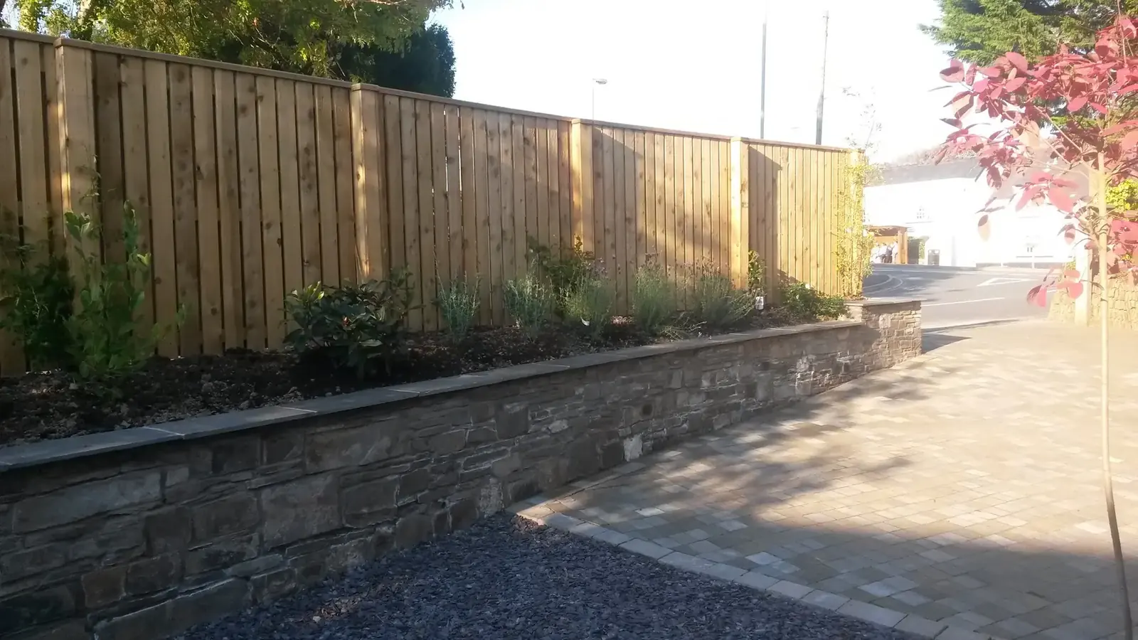 Landscaped driveway with retaining wall and planting
