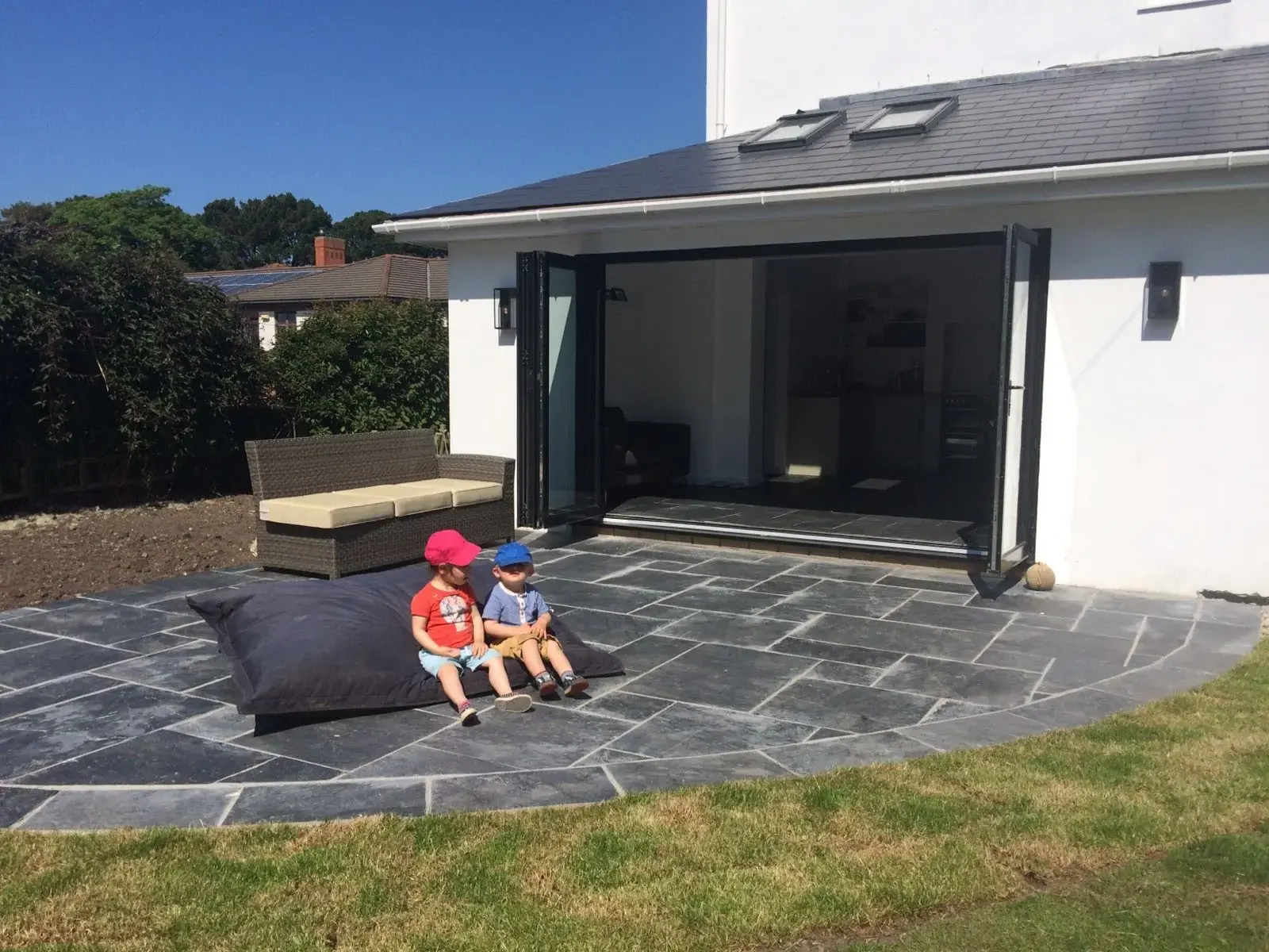 Slate patio meeting a neatly finished lawn