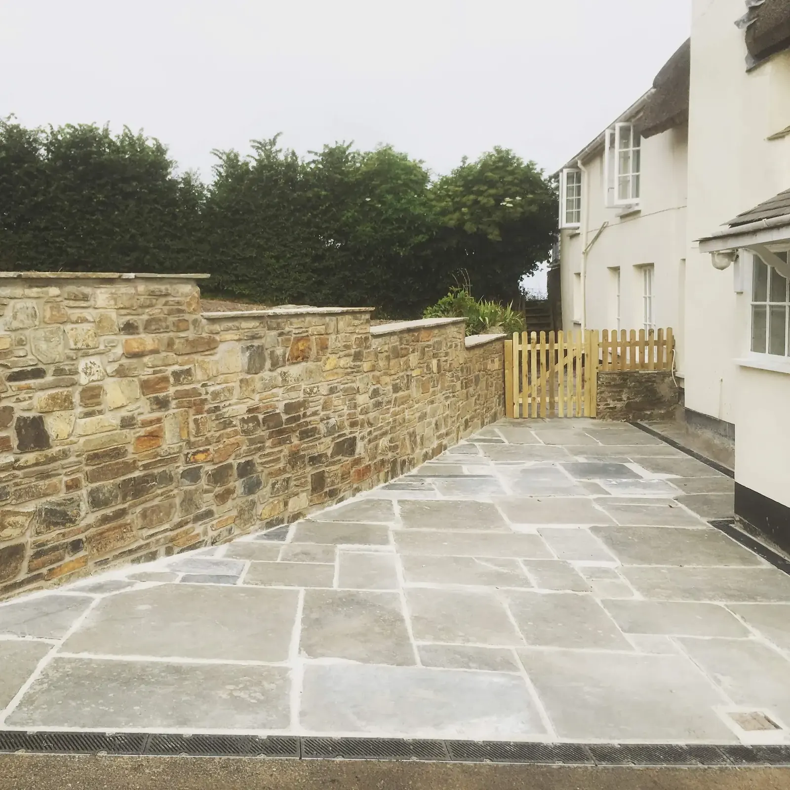 Finished stone courtyard with curved path and planting