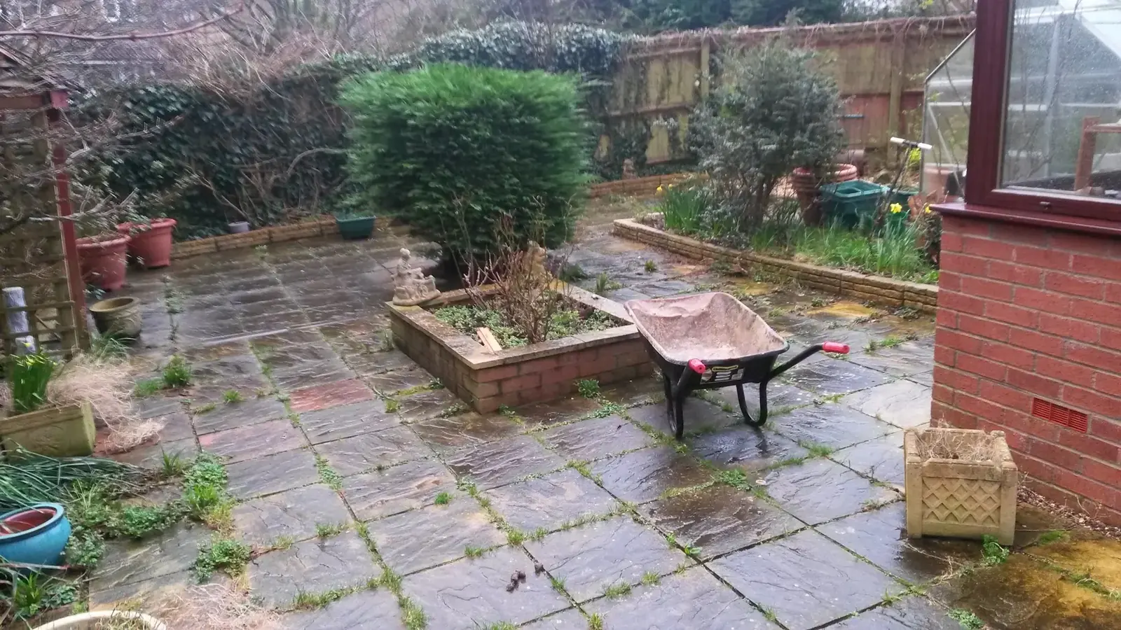Tired garden patio before landscaping work